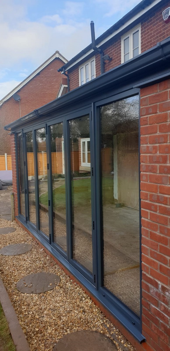 Visofold Bifolding Doors Powder Coated Grey on lean to roof conservatory